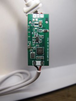 Symphony USB SPI Controller Electronic Board Photo of an electronic board with several components and a connected white wire.