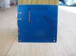Back of a Blue Circuit Board Back of a blue circuit board with visible traces and mounting holes.