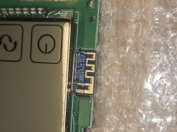 Wireless module on PCB next to LCD screen with power button symbol