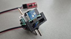 Close-up of a pogo pin jig for programming a PCB without soldering wires.