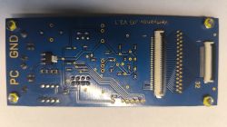 Niebieska płytka PCB programatora Vertyanov JIG v3.1 z widocznymi złączami i ścieżkami.