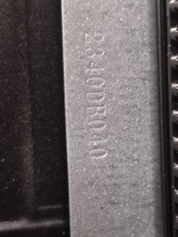 Engraved Numbers on a TV's Metal Part Close-up of a metal part with engraved numbers 2340DB040.