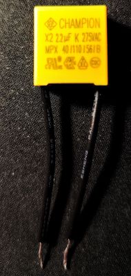 X2 2.2 uF 275VAC Capacitor X2 2.2 uF 275VAC capacitor with black wires on a dark background.