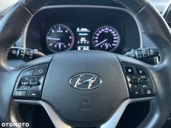 Hyundai steering wheel with control buttons and the instrument cluster in the background.