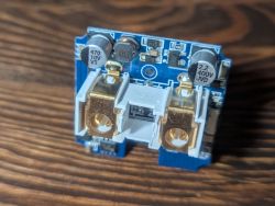 Close-up of a PCB with electronic components and relay terminals