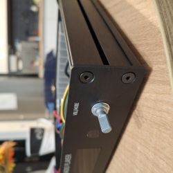 Close-up of black audio device front panel with encoder and VOL/MODE label