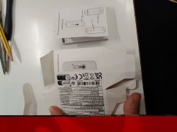 Temperature and humidity sensor packaging with user manual on a white tabletop