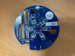 PCB with LEDs and Electronic Components Blue circular PCB with mounted LEDs and electronic components.