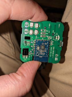 A person holding a printed circuit board with various electronic components.