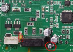 Circuit Board with Electronic Components Close-up of a circuit board with electronic components, including capacitors and integrated circuits.