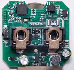Inside of a Smart Plug's Electronics Close-up of the inside of a smart plug showing electronic components on a green circuit board.