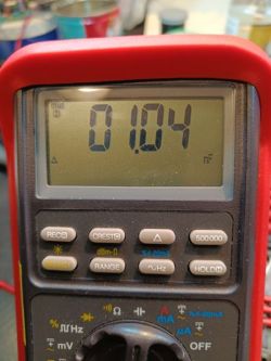 Photo of a multimeter with a display showing a reading of 1.04 nF.