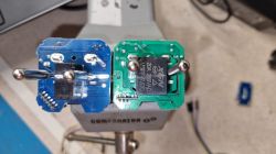 Two PCBs of different colors attached to a device.