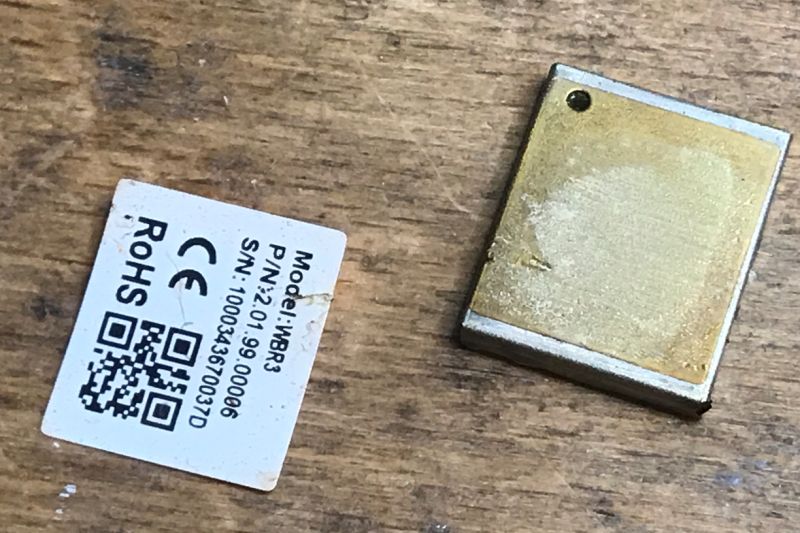 WBR3 electronic module with detached identification label on wooden surface