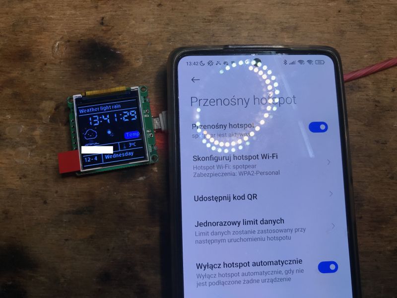 ESP32-C3 Module and Smartphone with Wi-Fi Hotspot ESP32-C3 module with display and smartphone with Wi-Fi hotspot settings.