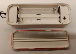 Opened housing of a sensor showing dual AAA battery slots