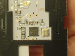 Electronic Circuit Board with Integrated Circuit and Quartz Resonator Close-up of an electronic circuit board with a visible integrated circuit and a 26.000 MHz quartz resonator.