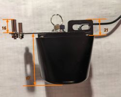 Black mechanical part with bracket and cable, overlaid measurements 16, 21, and 67