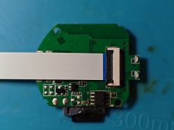 Printed circuit board with flat ribbon cable connected, on blue background