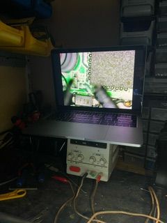 Laptop on desk displaying a circuit board.
