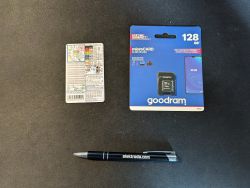 MicroSD card, resistor chart, and pen on a black background