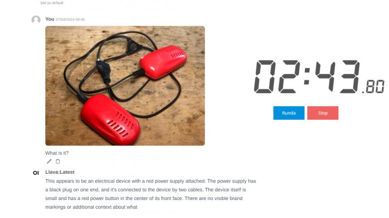 Red electrical device with cables on a wooden background.