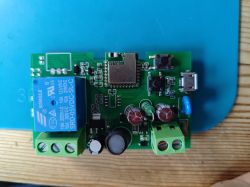 Relay on a green circuit board on a blue mat.
