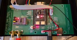 Close-up of an ESP32 Web Radio PCB with connected wires and components.