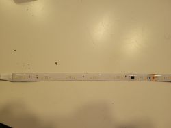LED strip with multiple diodes on a light background.