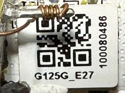 Close-up of the interior of an LED light bulb with a visible QR code and markings.