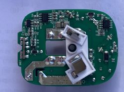 Green PCB with SMD components and a white holder with metal contacts in the center