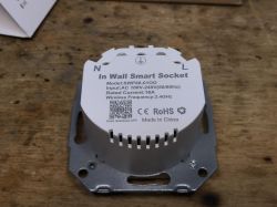 SWP86-01OG Wall-Mounted Smart Socket “In Wall Smart Socket” SWP86-01OG wall-mounted smart socket on a wooden surface.
