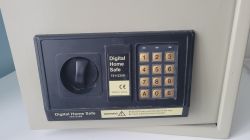 Blat elektronicznego sejfu domowego z klawiaturą numeryczną i pokrętłem.