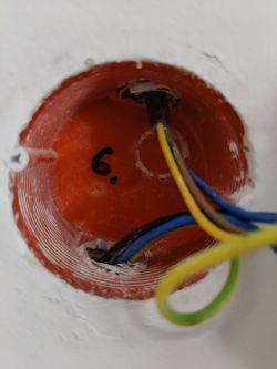 Electrical box with three colored wires protruding.