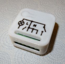 White electronics enclosure with L and N markings and relay circuit symbol