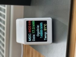 A small electronic display showing energy and temperature data.