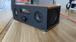 Homemade radio in a wooden case with display and knob on a wooden table