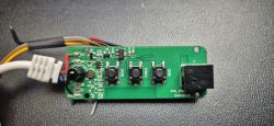 LED Controller Circuit Board with Buttons and Wires Circuit board with three buttons and colored wires.