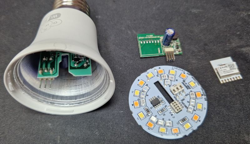Disassembled Interior of RoomLux B15515 A60 Bulb Disassembled components of the RoomLux B15515 A60 bulb with visible circuit boards and WiFi module.