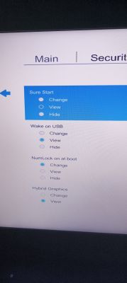 Zdjęcie ekranu ustawień BIOS/UEFI komputera, pokazujące opcje Sure Start, Wake on USB, NumLock on at boot i Hybrid Graphics.