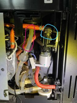 Interior of a coffee machine with marked areas of leaks and deposits.