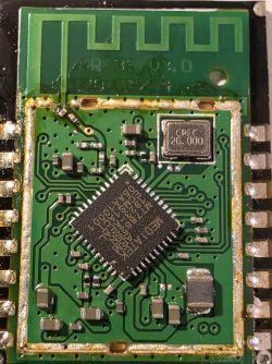 Close-up of a green PCB module with an IC chip and a metal can marked “CREC 26.000”
