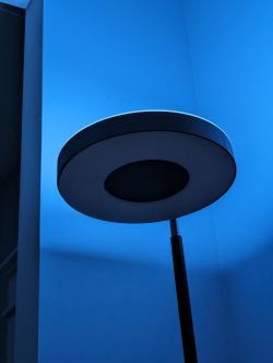 Modern Floor Lamp with Light Disc Modern floor lamp with blue lighting on the wall.