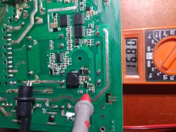 Voltage measurement on a circuit board with a multimeter.