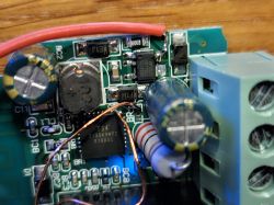 Close-up of a PCB with visible electronic components, including capacitors and a resistor labeled BR4.