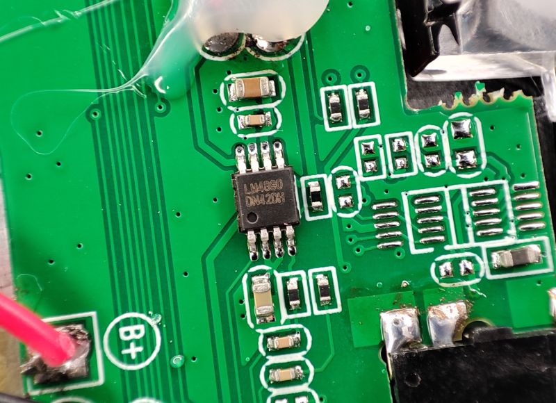 Close-up of a green PCB with an LM4890 chip and SMD parts, next to a B+ pad.
