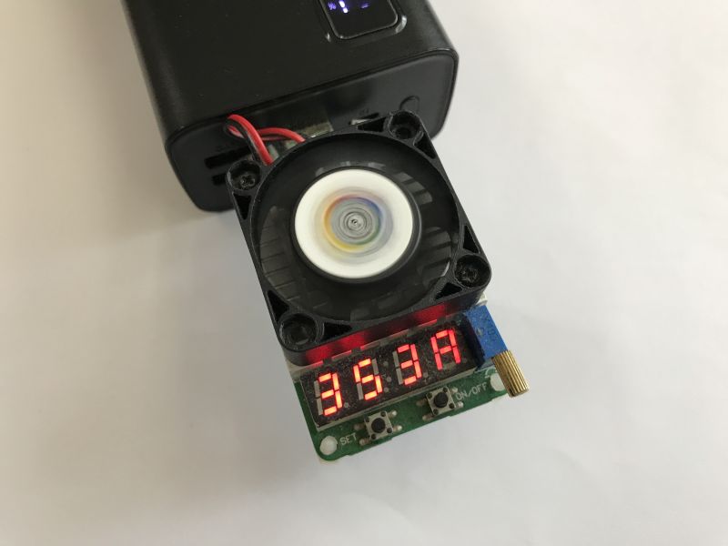 Power bank with USB load tester showing 3.63 A on digital display