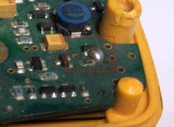 Close-up of a metal detector PCB with a damaged resistor.