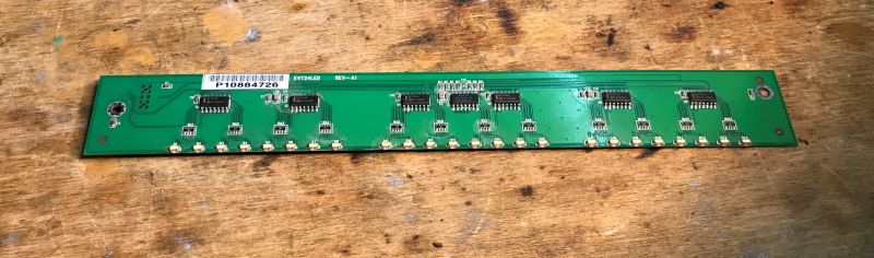 Board with HC164A Chips and LEDs Circuit board with integrated circuits and LEDs on a wooden surface.