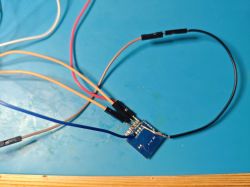 Connecting an Electronic Module Electronic module with connected wires on a blue surface.